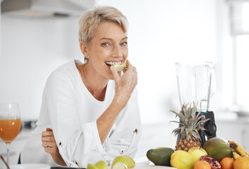 Portrait, fruit salad and apple with an elderly woman in the kitchen of her home for health, diet or nutrition. Smile, food and cooking with a happy senior female pensioner eating healthy in a house