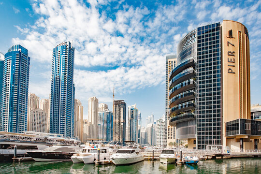 Dubai, UAE &ndash; april 11, 2023: Dubai Marina, Pier 7, Address Dubai Marina, InterContinental IHG Hotel, yahts, boats, at day, waves