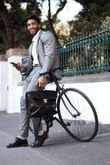 Fototapeta na wymiar Bicycle, portrait and business man with phone in a city for texting, social media and cycling break. Bike, commute and male person with smartphone in a street for location, search and GPS navigation