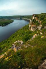 Canyon with the river Dniester on an summer day near the village of Subich. Podolsk Tovtry. Beautiful nature landscape. Mountains and forest, Ukraine. Vertical photo.
