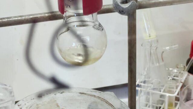Colourful reactions under heating condition in sand bath. 4K video experiments in a chemistry lab. Biochemical medicine synthesis in the laboratory.