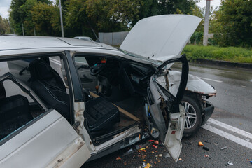 A car accident involving two cars on a city street. Damaged cars. Severe accident. Close-up.