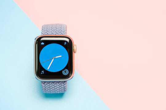 Seoul - 01.06.2023: Apple Watch with strap on blue and pink background close-up.