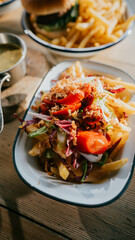 A plate of spaghetti with shrimps on a restaurant table.
