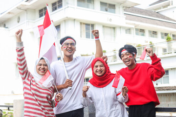 Excited young people raised arm on Indonesian independence day celebration