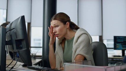 Tired employee working computer in office. Overwhelmed woman analyzing sales