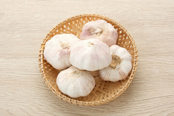 Fresh garlic (bawang putih) on a wooden table
