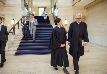 Judges and lawyers walking through courthouse 