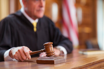 Judge banging gavel in court  - Powered by Adobe