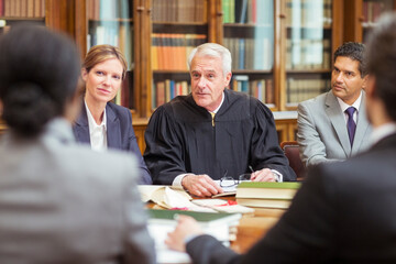 Judge talking with lawyers in chambers