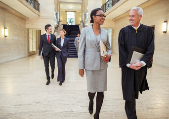 Judges and lawyers walking through courthouse 