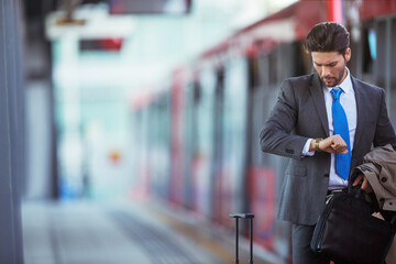 Businessman checking his watch in train station