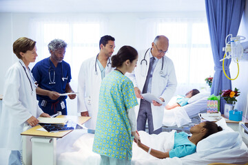 Doctors and nurse making rounds in hospital room