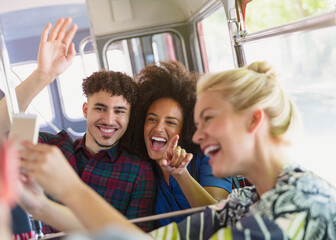 Enthusiastic friends taking selfie on bus - obrazy, fototapety, plakaty
