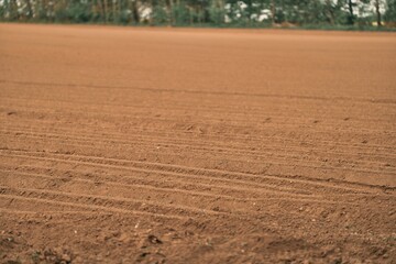 The agricultural landscape showcases the vast expanse of the field, which is prepared for farming...
