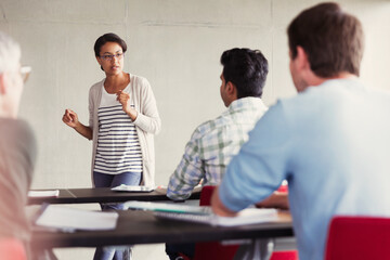 Teacher speaking to students in adult education classroom