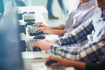 Students typing at computers in adult education classroom