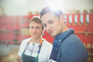 Portrait confident carpenter in workshop