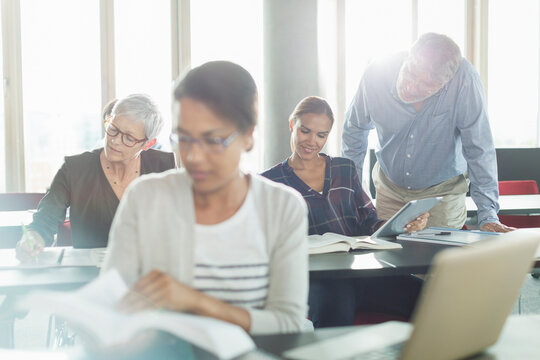 Students studying in adult education classroom