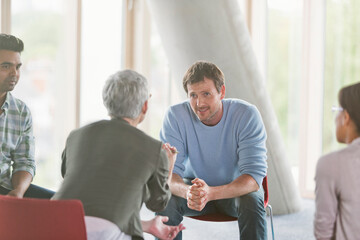 Business people talking in group meeting