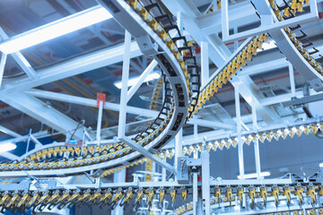 Winding printing press conveyor belts overhead