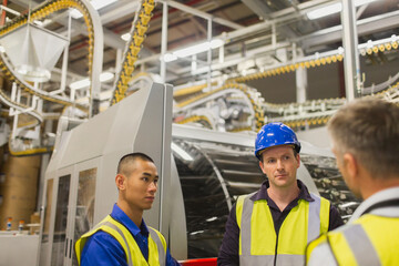 Workers talking in printing plant
