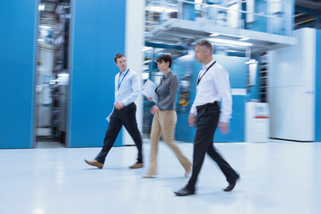 Workers walking in factory