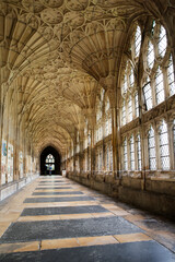 Fototapeta na wymiar Cloisters of the Romanesque gothic Gloucester cathedral with Fan vaulted ceiling, used extensively as location for the Harry Potter film series