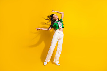 Full body photo of carefree excited nice lady enjoy dancing outfit clothes ad isolated on yellow color background