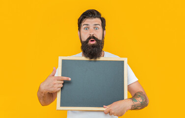 shocked man presenting sale in studio. photo of man presenting sale at blackboard.