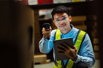 A warehouse worker is inspecting a cardboard box. Delivered in the logistics system Product distribution center. Logistics and export business. Factory warehouse.