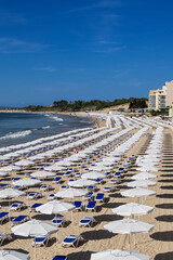 Fototapeta na wymiar Beach with umbrellas in sea resort on Black Sea