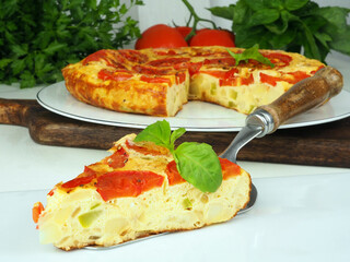 Omelet or tortilla or casserole with tomatoes and zucchini