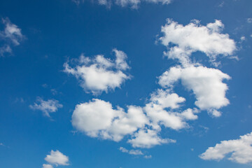puffy small clouds at a blue sky gives a harmonic background