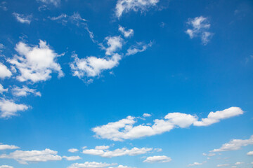 puffy small clouds at a blue sky gives a harmonic background