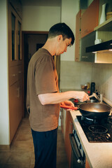 
man cooking in the kitchen on the stove