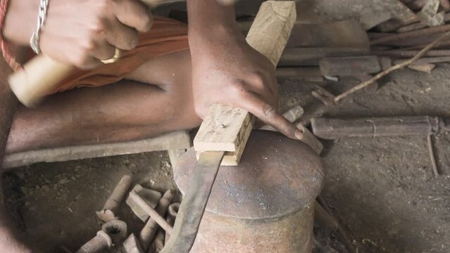 Hammering nail into Koduval cocunut knife