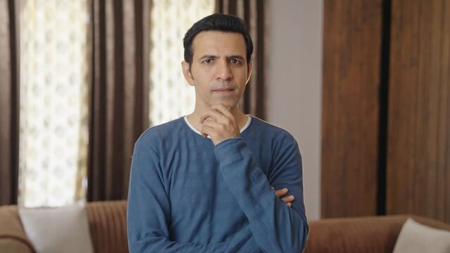 Middle aged Indian man thinking and observing