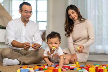 Obraz na płótnie Canvas Portrait of enjoy happy love family asian father and mother playing with adorable little asian baby.newborn, infant.dad touching with cute son moments good time play toy.Love of family