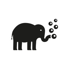 An elephant blowing soap bubbles from his trunk.