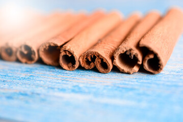 Orange cinnamon sticks with sun lights on the kitchen table.