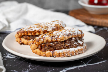 Apple cookies. Tasty cookies filled with applesauce on a dark background. Close up