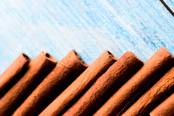 Orange cinnamon sticks with sun lights on the kitchen table.