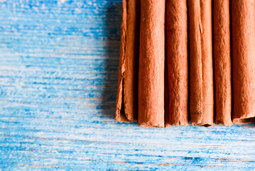 Orange cinnamon sticks with sun lights on the kitchen table.