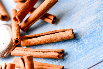 Orange cinnamon sticks with sun lights on the kitchen table.
