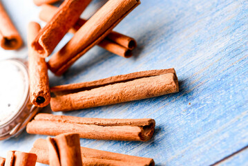 Orange cinnamon sticks with sun lights on the kitchen table.