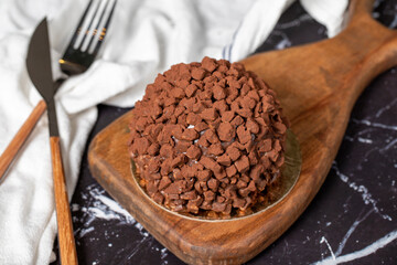 Chocolate cake. Mole cake with chocolate chips on dark background
