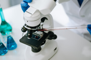 Male scientist researcher conducting an experiment in laboratory..