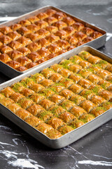 Turkish baklava. Pistachio and walnut baklava on a dark background. Turkish cuisine delicacies