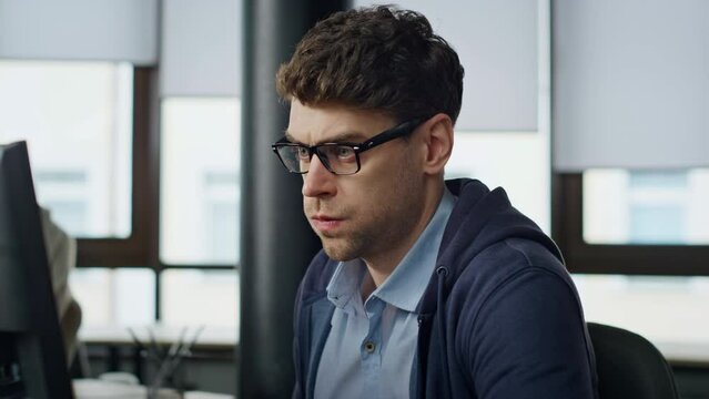 Stressed businessman analyzing computer report closeup. Nervous it manager look